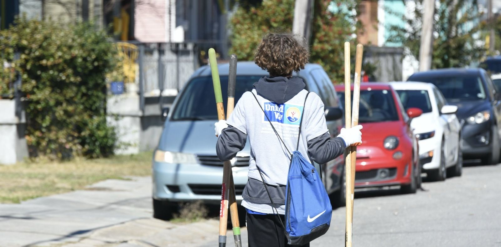 Volunteer Engages In Environmental Cleanup With Tools In Hand