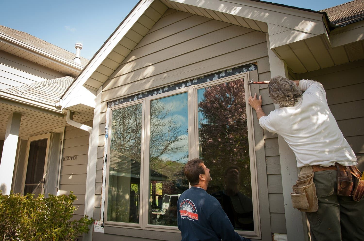 Window Replacement Contractors Hammering New Window Trim