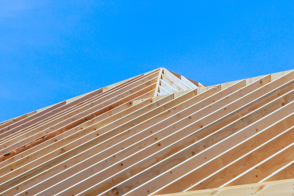 Angled View Of Wooden Roof Trusses And Sheathing Preparation On Residential Construction